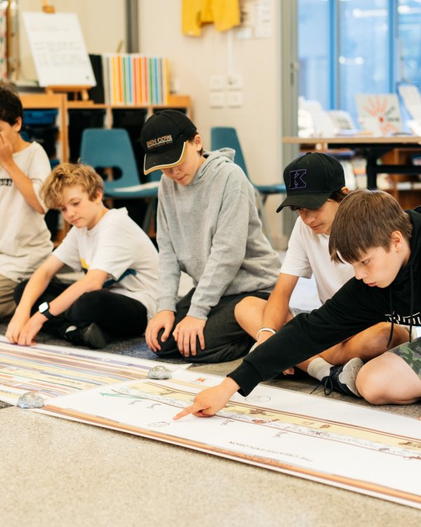 kids looking at a timeline on paper