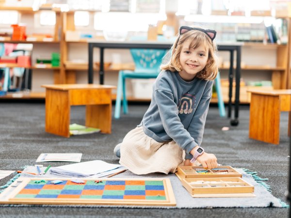 Girl learning on mat Image